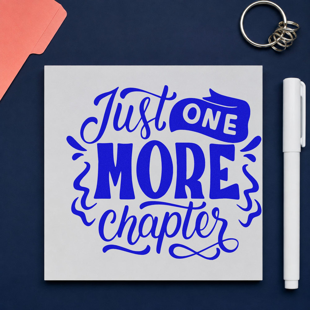 Just One More Chapter craft stamp imprinted in blue ink on paper, a design suited to book post seals.