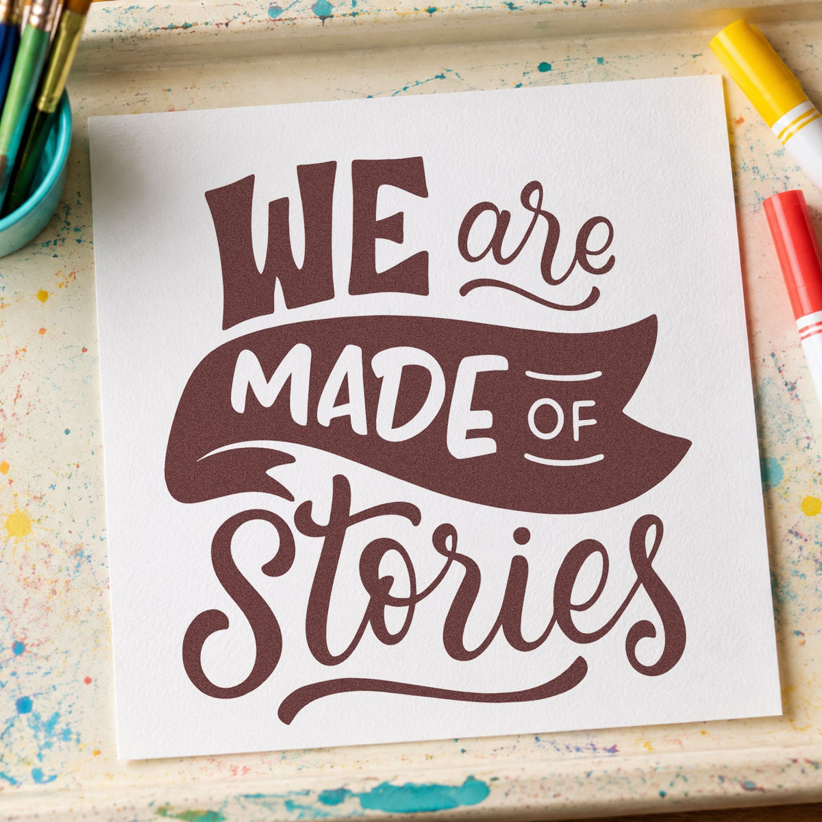 We Are Made Of Stories rubber stamp printed in brown ink, ready for archive sleeve labels and similar paper crafts.