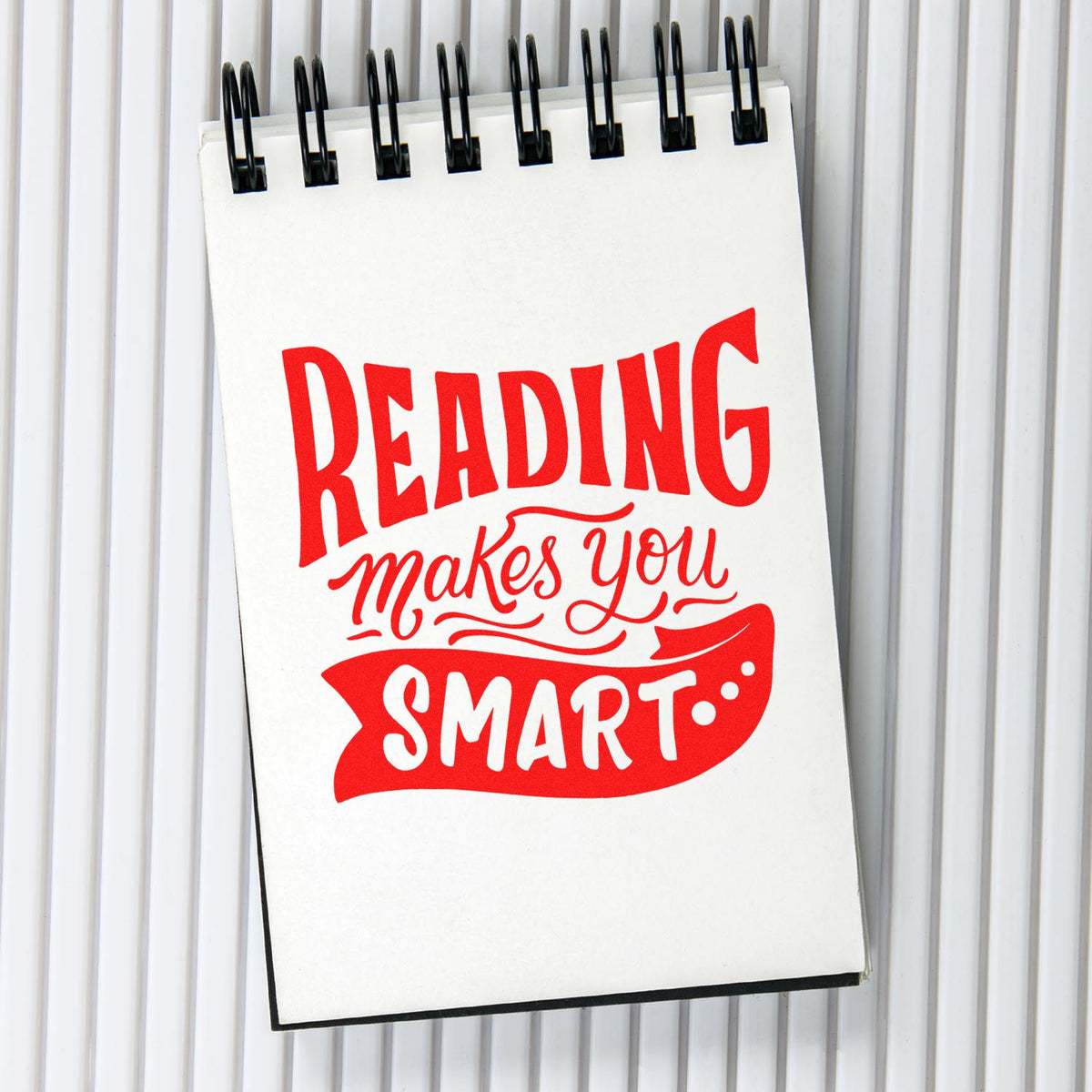 Reading Makes You Smart rubber stamp shown in red ink, stamped for projects such as challenge tags.
