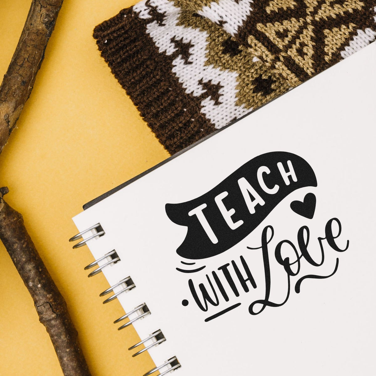 Teach with Love teacher rubber stamp design on notebook for classroom crafts, teacher appreciation, and handmade projects.