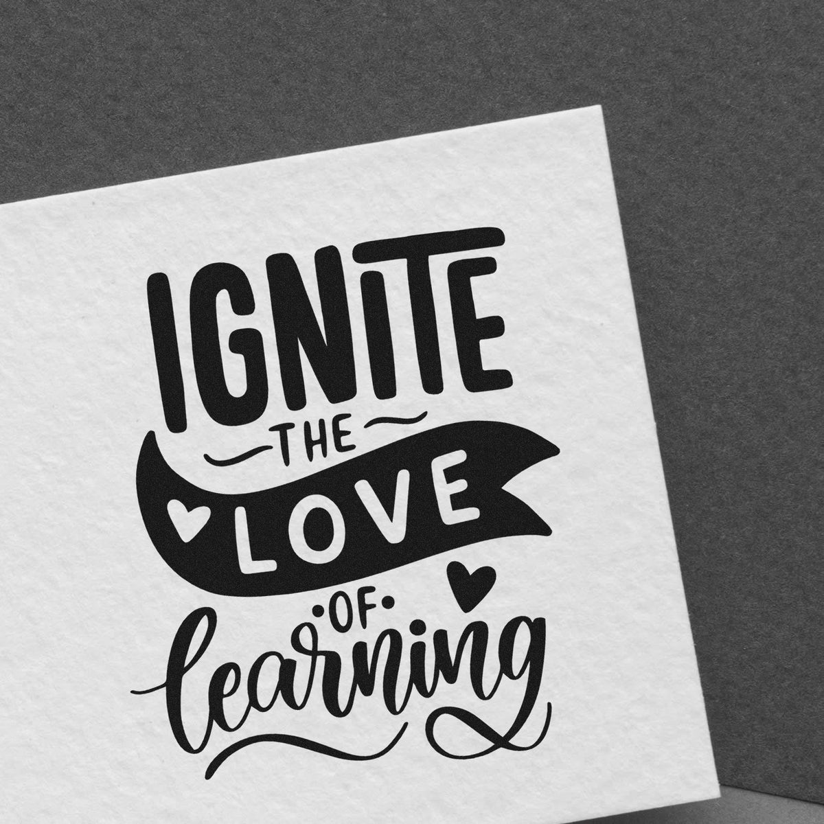 Ignite the Love of Learning rubber stamp design for teachers, with bold lettering and hearts for classroom use.