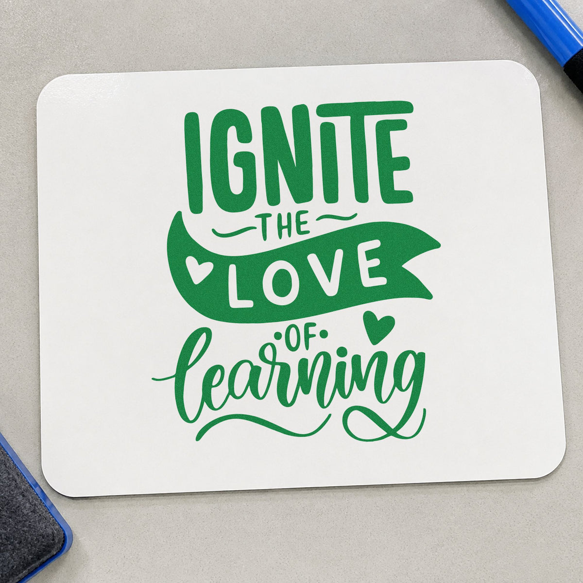 Ignite Love Of Learning craft stamp imprint in green ink on a handmade project, one idea being inquiry sheet pages.