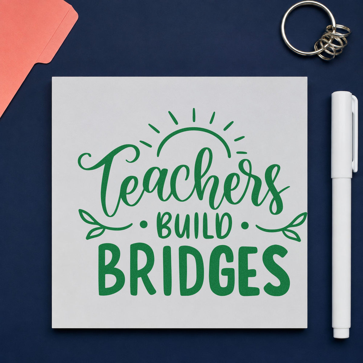 Teachers Build Bridges craft stamp imprint in green ink on a handmade project, one idea being handover form pages.