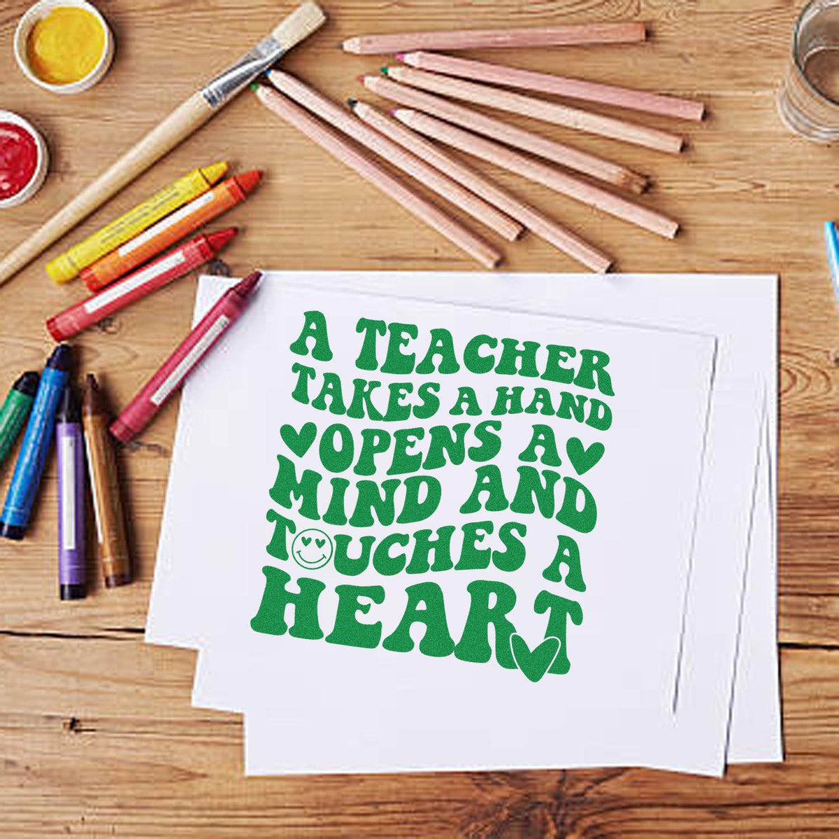 Teacher Takes Hand Touches Heart rubber stamp shown in green ink, stamped for projects such as buddy pair tags.