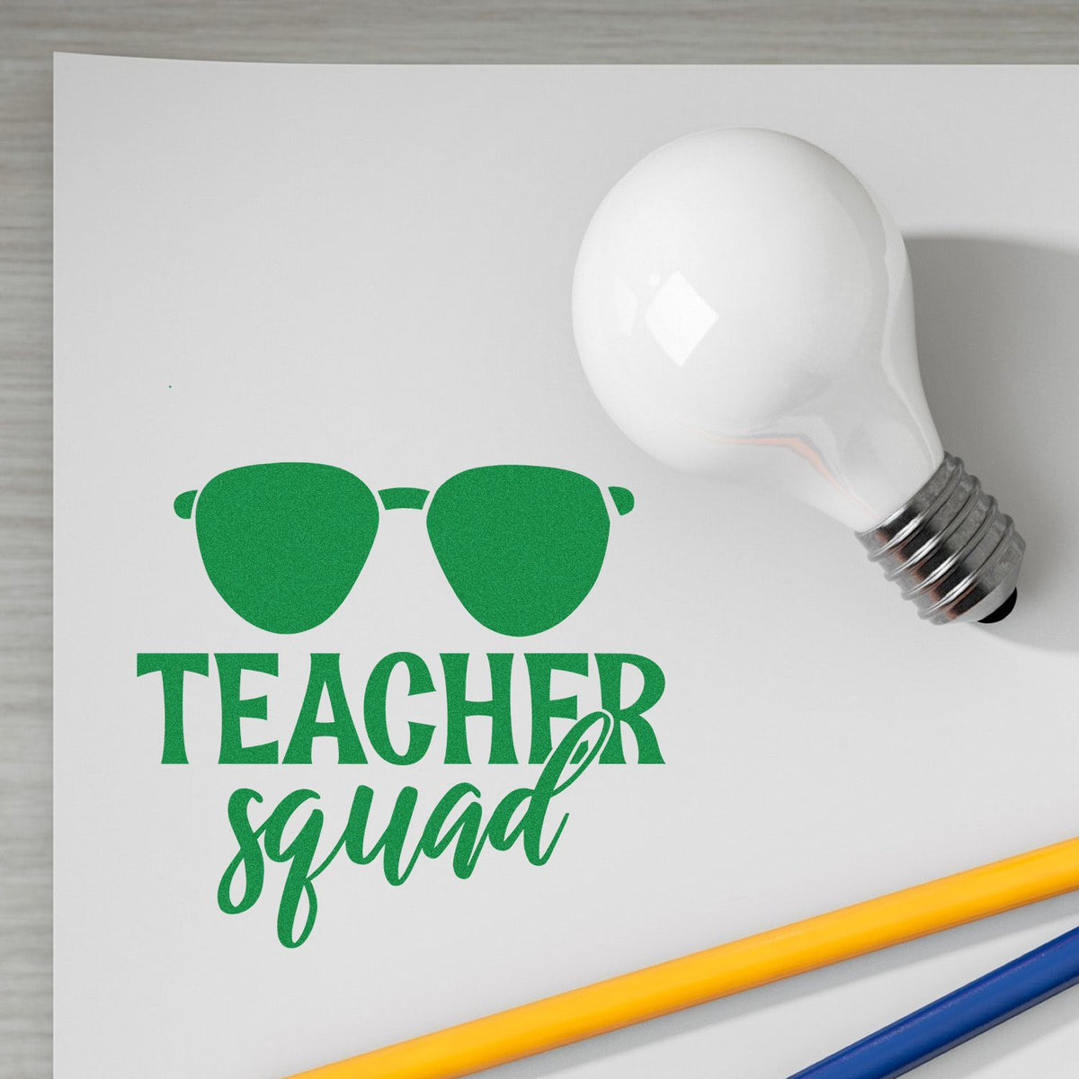 Teacher Squad rubber stamp design with sunglasses and light bulb for teacher appreciation or classroom crafts.