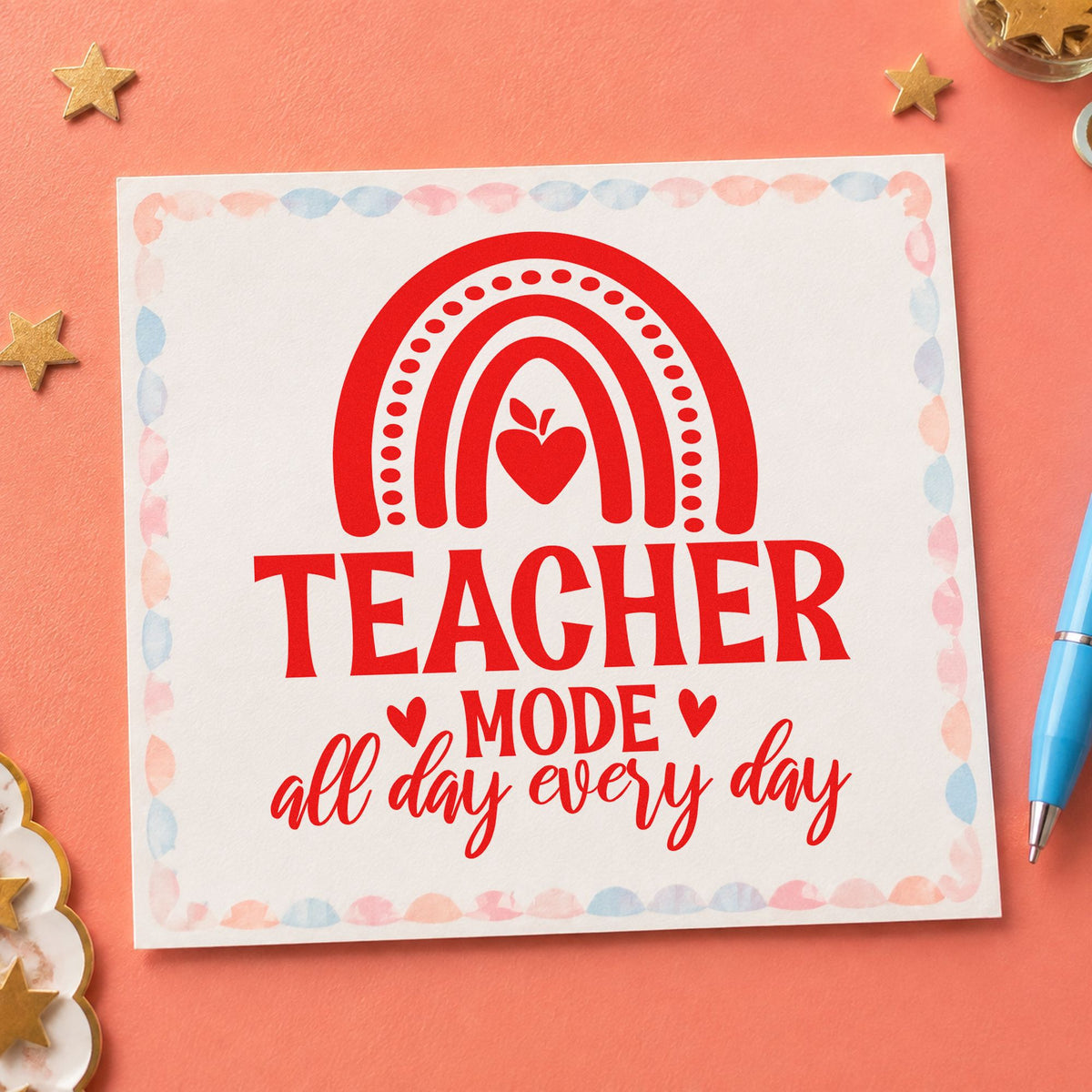 Teacher Mode Rainbow Apple rubber stamp shown in red ink, stamped for projects such as long week notes.