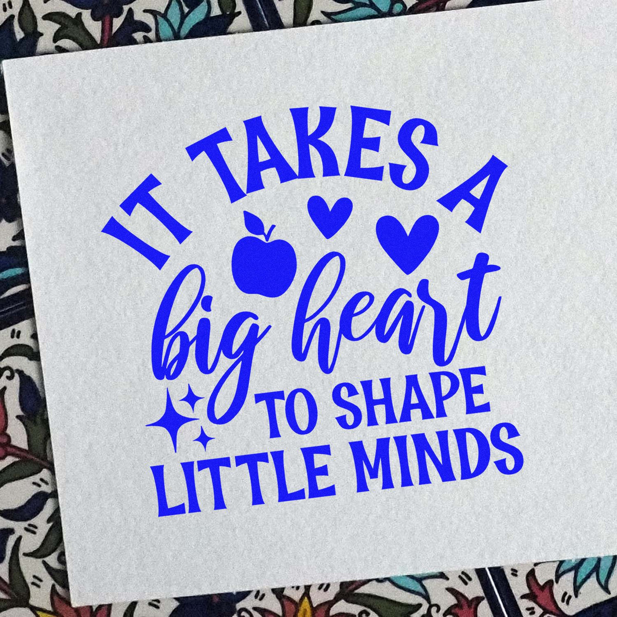 Blue rubber stamp design reading It takes a big heart to shape little minds with apple, hearts, and stars for teachers.