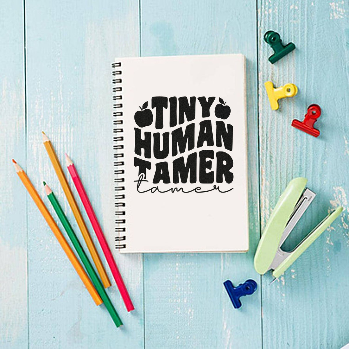 Tiny Human Tamer rubber stamp design on notebook for teachers, parents, and classroom organization.