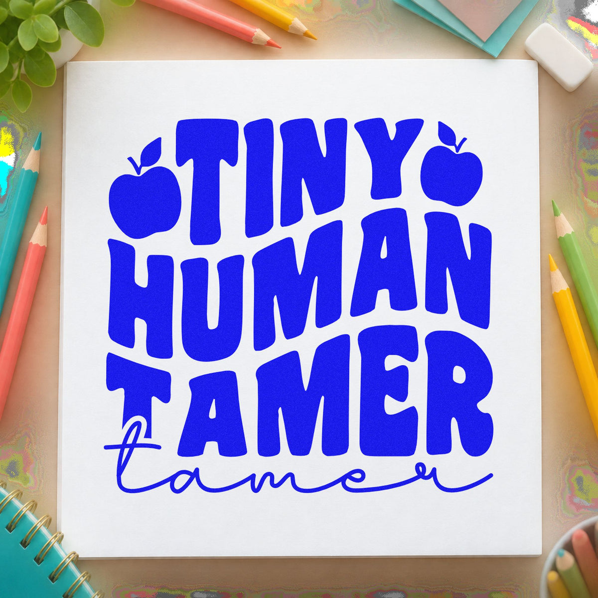 Tiny Human Tamer Apples craft stamp in blue ink on cardstock, an easy option for staff polo panels.
