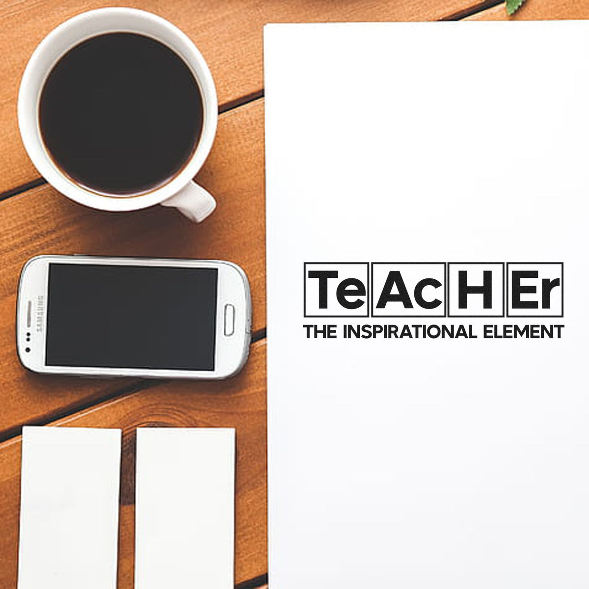 Teacher inspirational rubber stamp design mockup on paper beside coffee cup, smartphone, and blank cards.