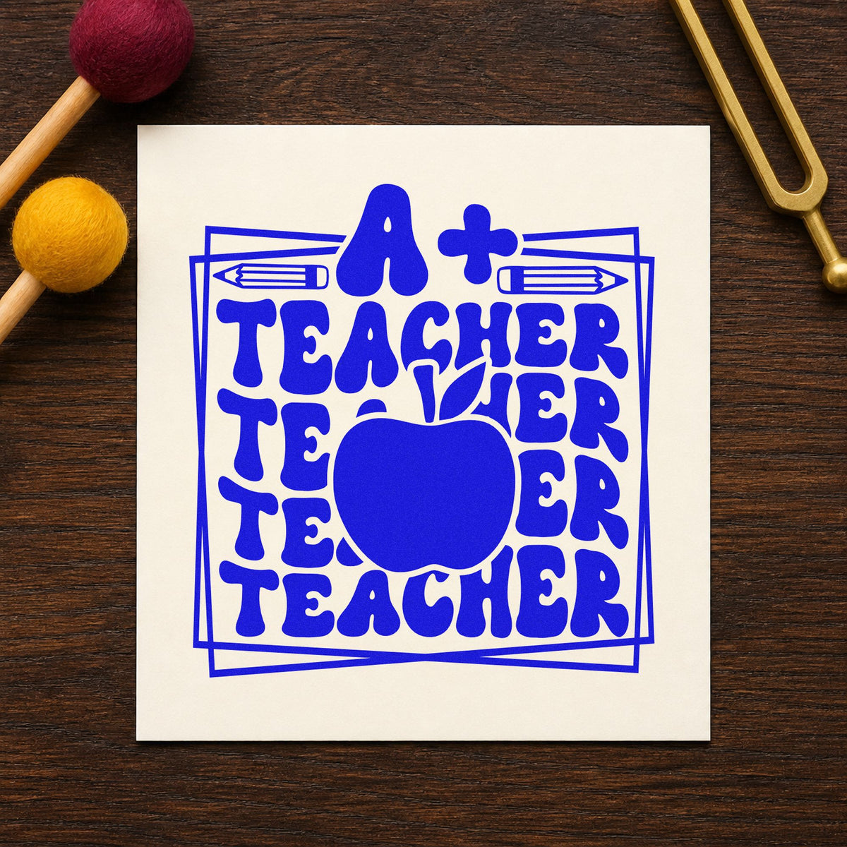 A Plus Teacher Repeated Frame craft stamp imprinted in blue ink on paper, a design suited to paper pack seals.