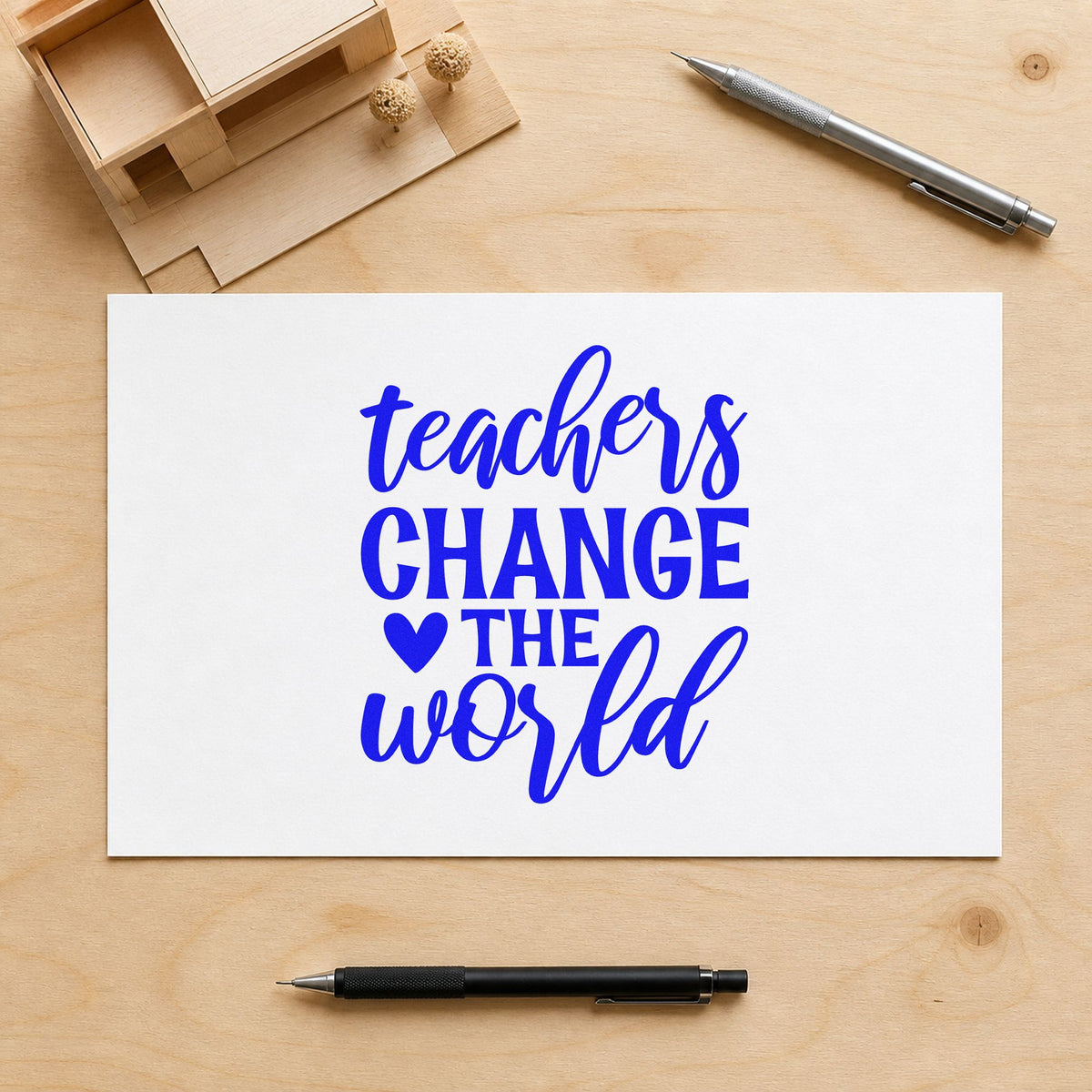 Teachers Change The World Heart craft stamp in blue ink on cardstock, an easy option for volunteer tee panels.