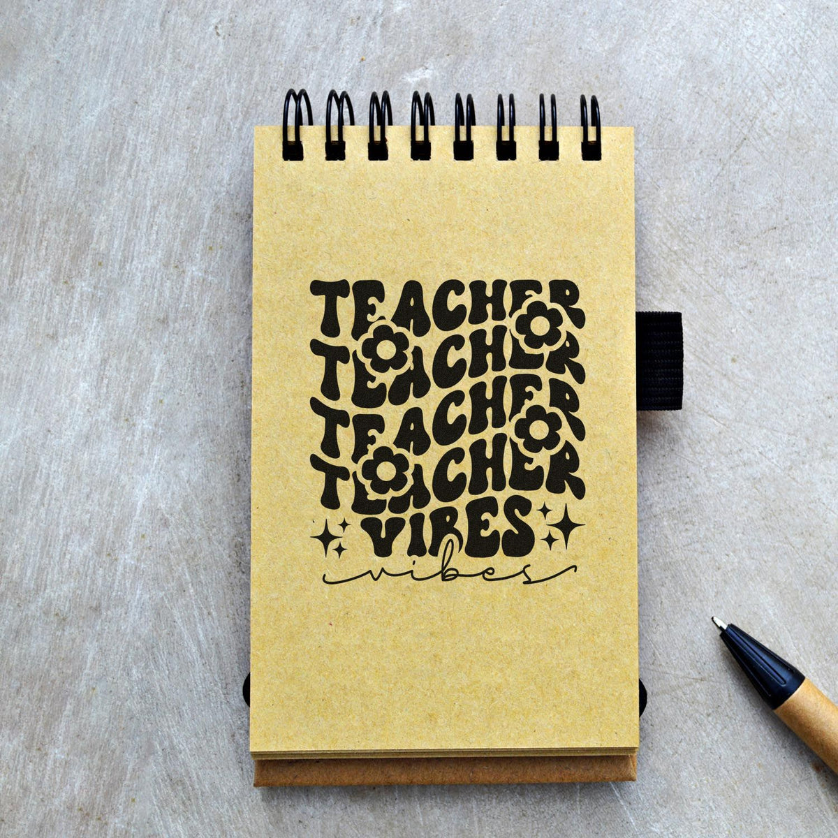 Custom Teacher Vibes rubber stamp on spiral notebook, perfect for teacher stationery, planner pages, and classroom crafts.