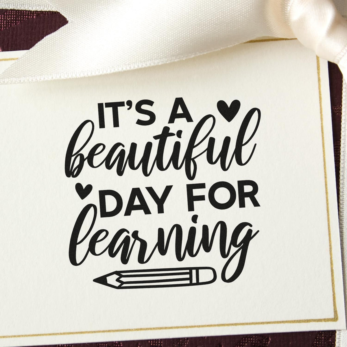 Teacher rubber stamp with Its a Beautiful Day for Learning quote and pencil icon on a gift tag.