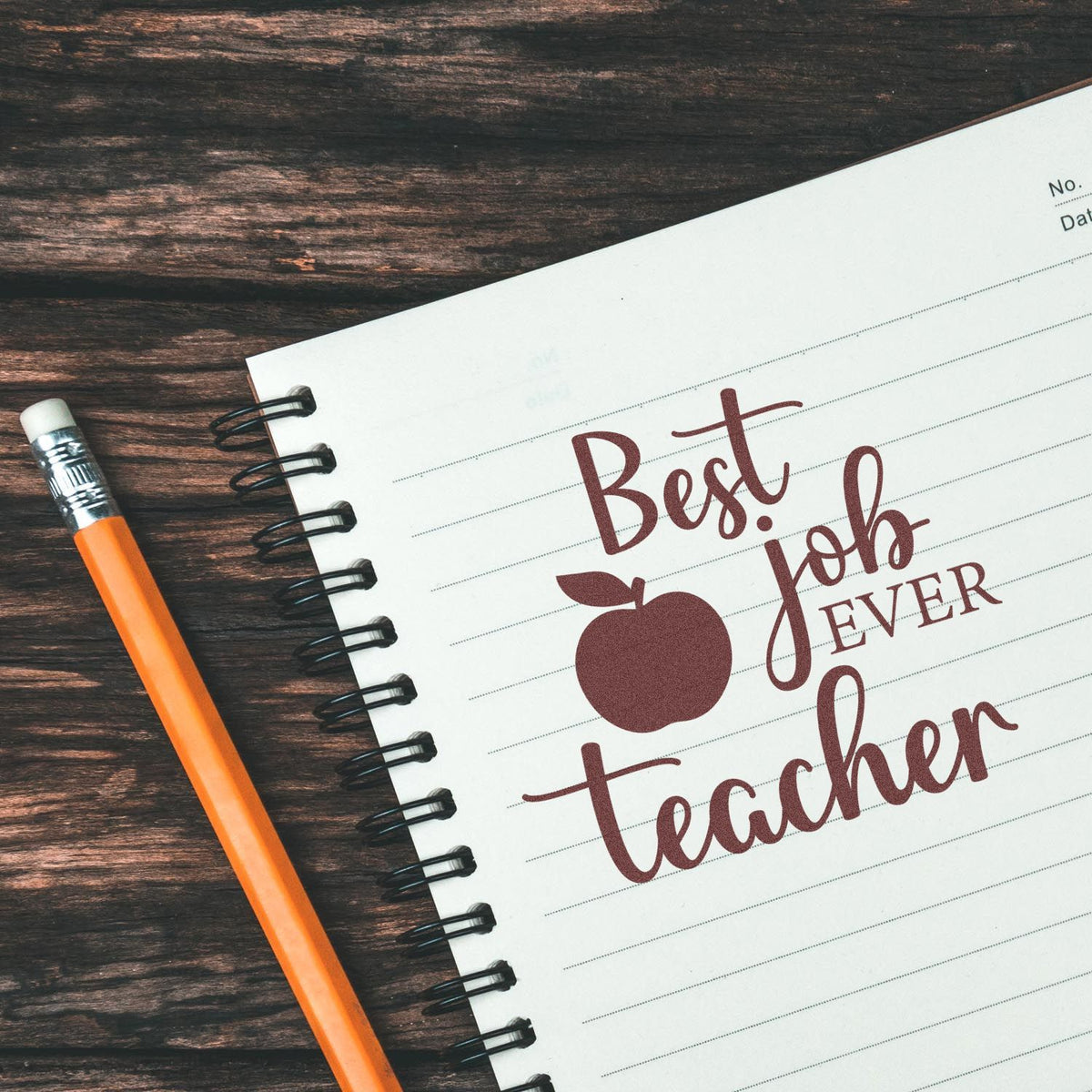 Teacher rubber stamp design with Best Job Ever and apple icon on notebook, ideal for classroom appreciation gifts.