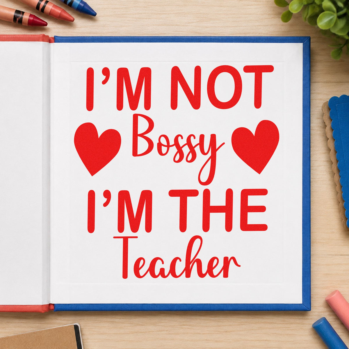 Not Bossy I'm The Teacher rubber stamp shown in red ink, stamped for projects such as cover lead notes.