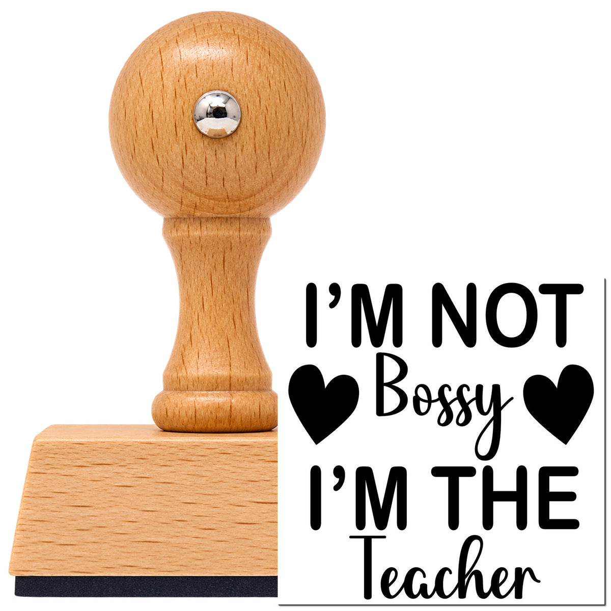I'm Not Bossy I'm The Teacher Vintage Pro rubber stamp in European beech wood with a round knob handle, shown beside its black imprint.