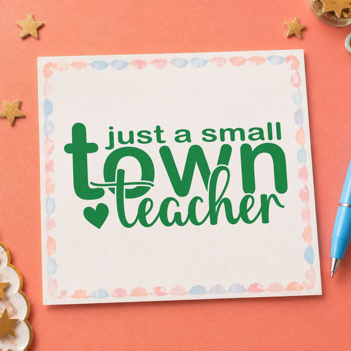 Small Town Teacher craft stamp imprint in green ink on a handmade project, one idea being framed hall noticeboard.