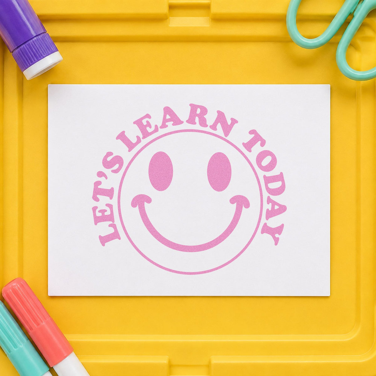 Let's Learn Today Smile craft stamp in purple ink on cardstock, an easy option for welcome desk tags.