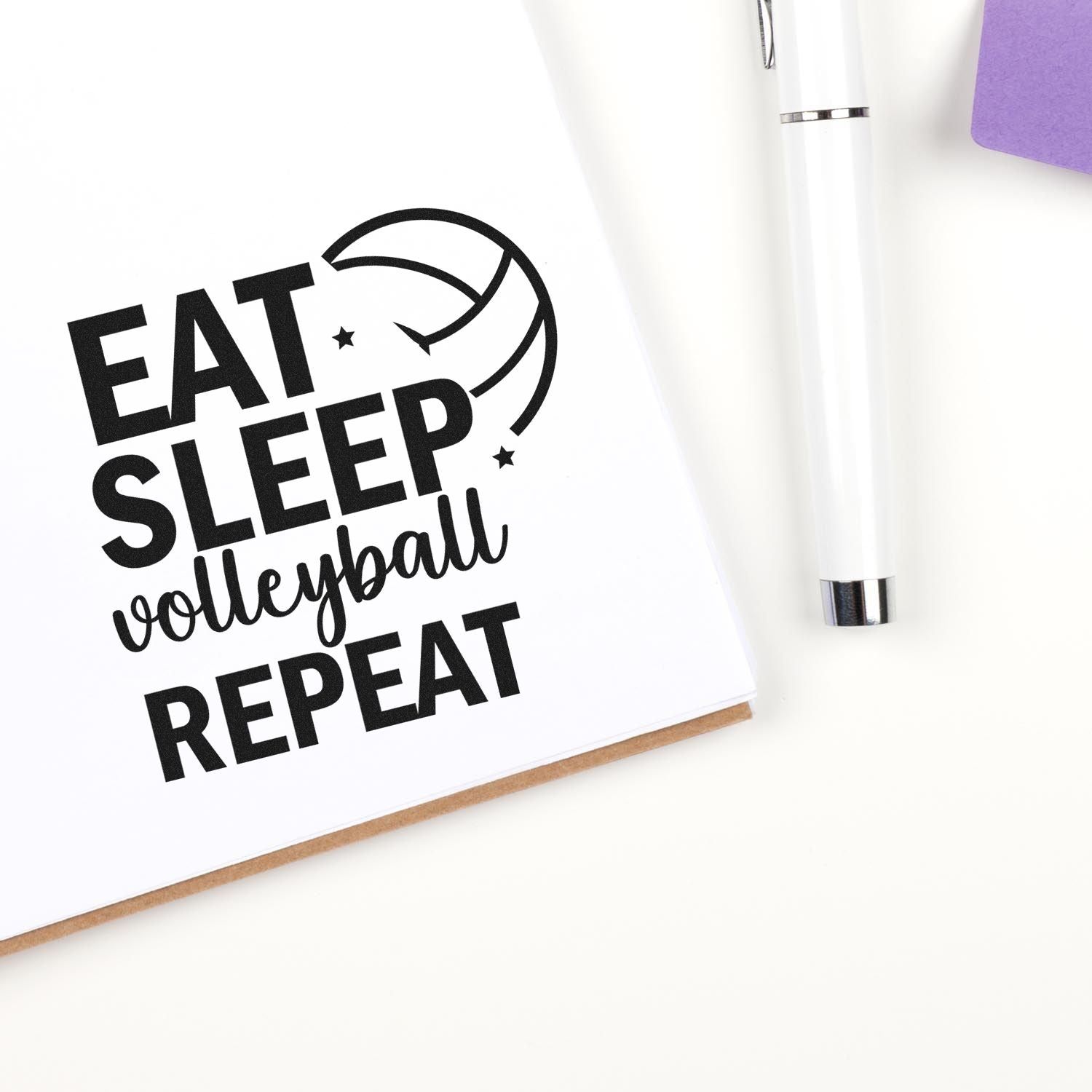 Eat Sleep Volleyball Repeat rubber stamp design on notebook, ideal for volleyball coaches, players, and sports craft projects.