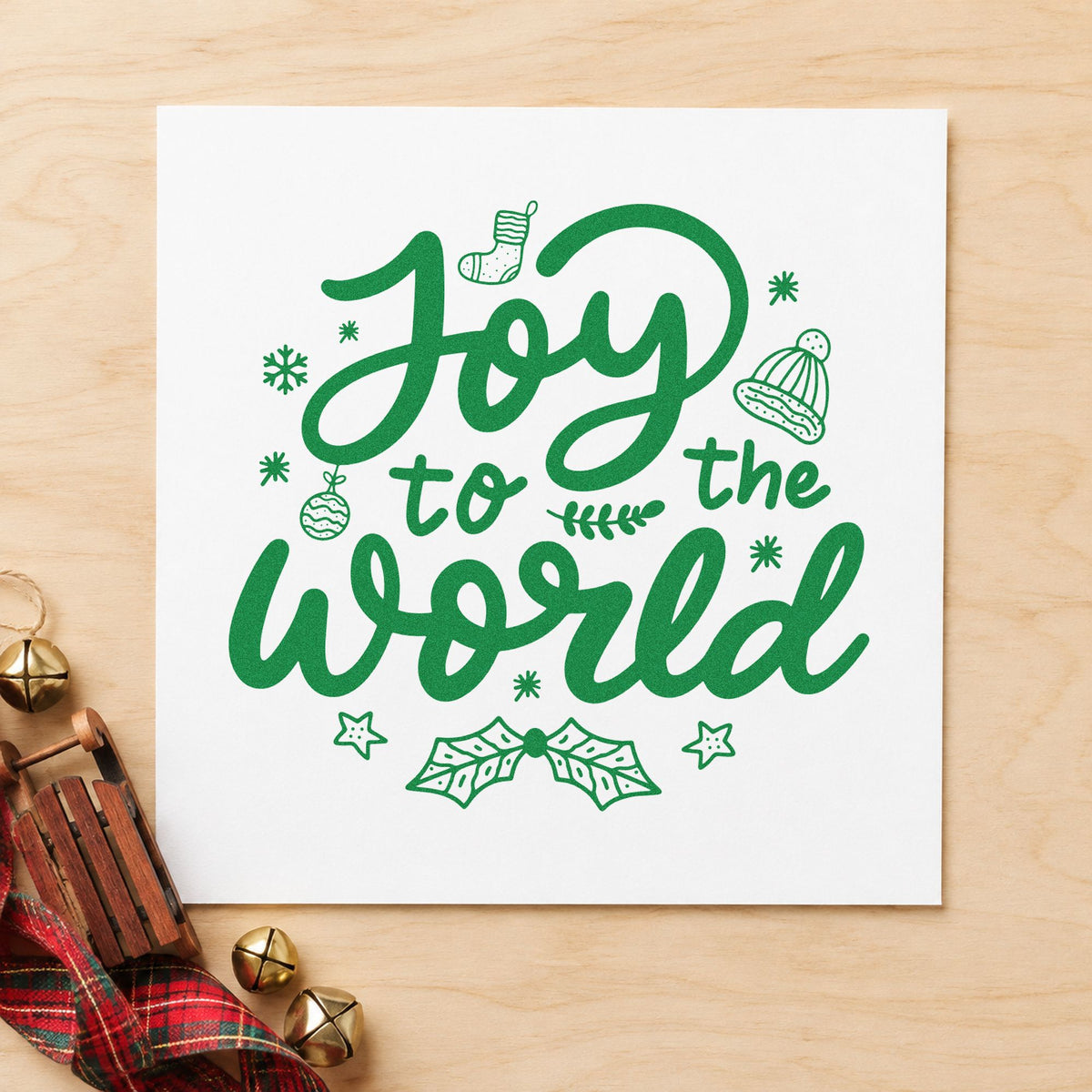 Joy To The World craft stamp imprint in green ink on a handmade project, one idea being december scrapbook pages.