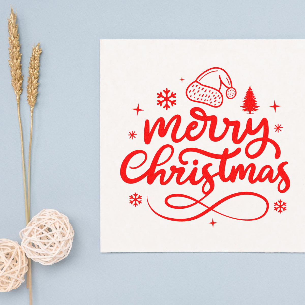 Red Merry Christmas rubber stamp design with Santa hat, snowflakes and tree, perfect for holiday cards and craft stamping.