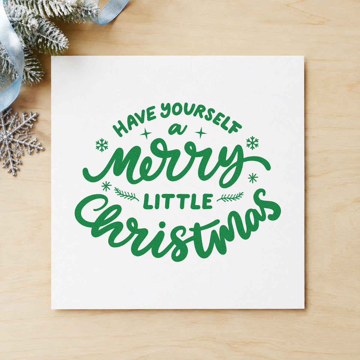 Have Yourself Merry Little Christmas craft stamp imprint in green ink on a handmade project, one idea being song book pages.
