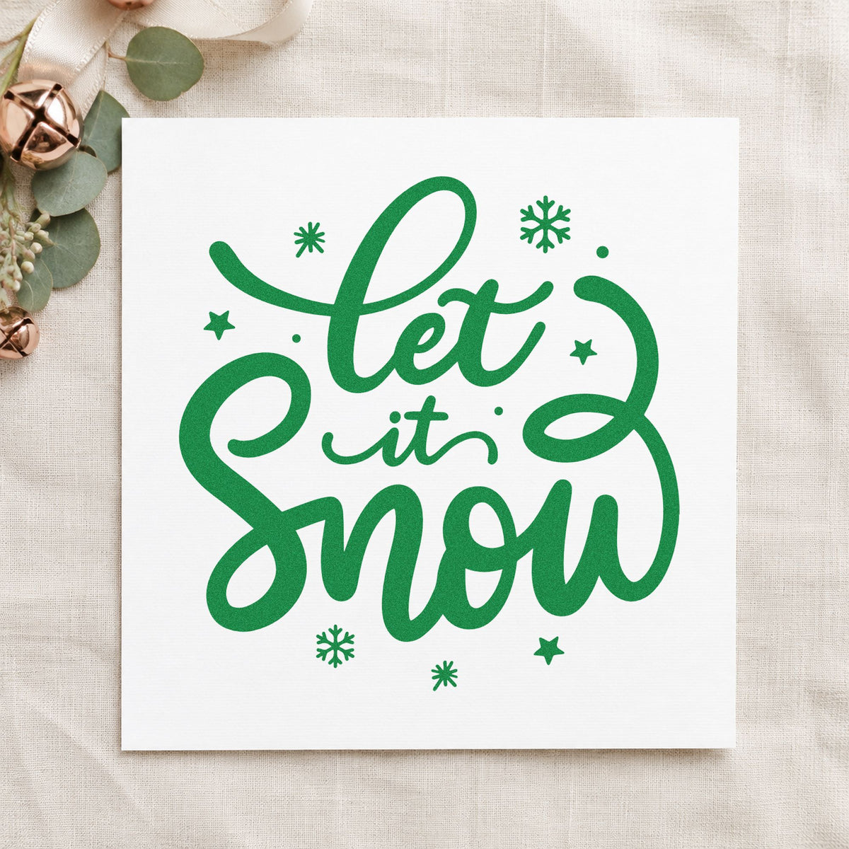 Let It Snow Script craft stamp imprinted in green ink on paper, a design suited to sledge bag seals.
