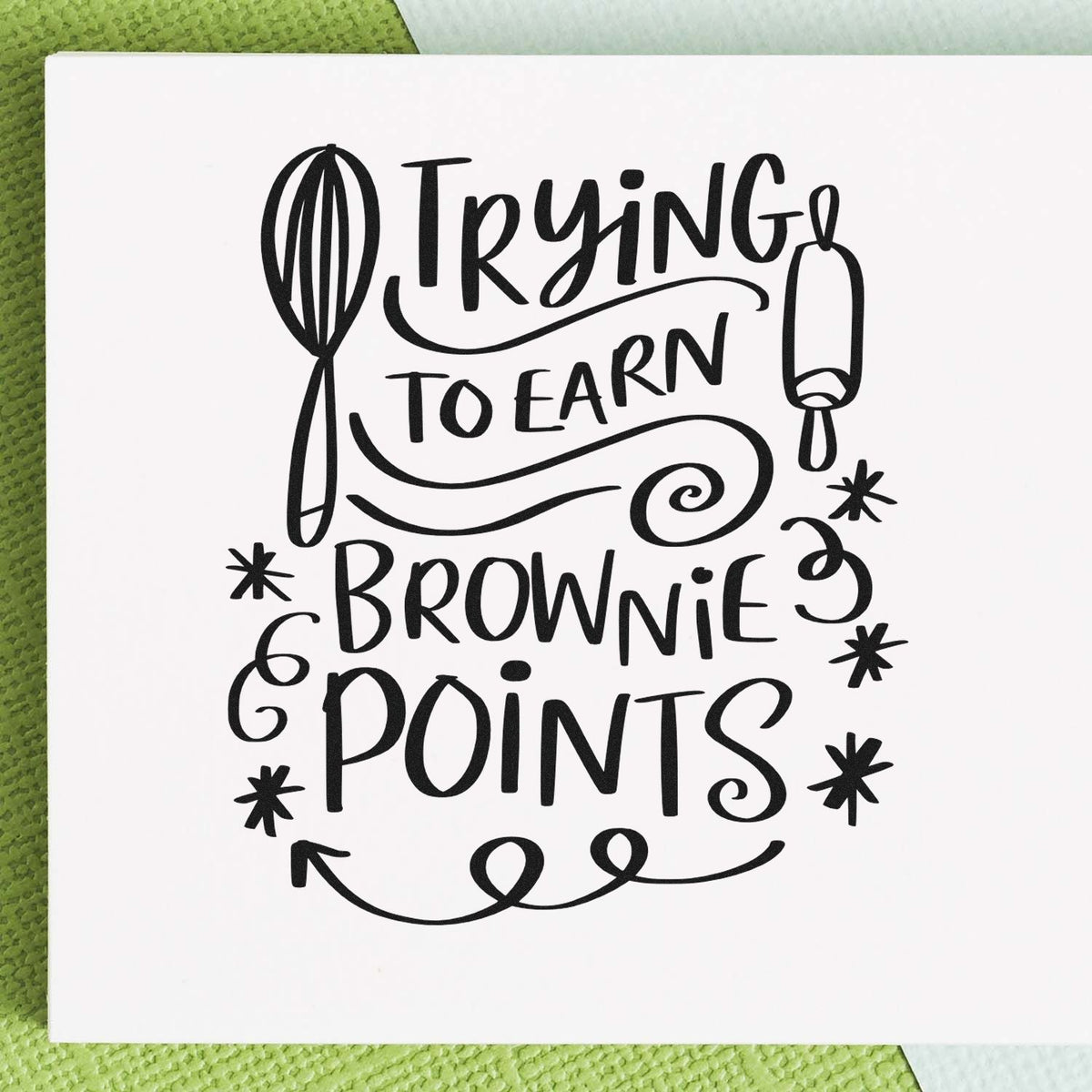 Baking rubber stamp reading Trying to Earn Brownie Points with whisk and rolling pin for baker cards and crafts.