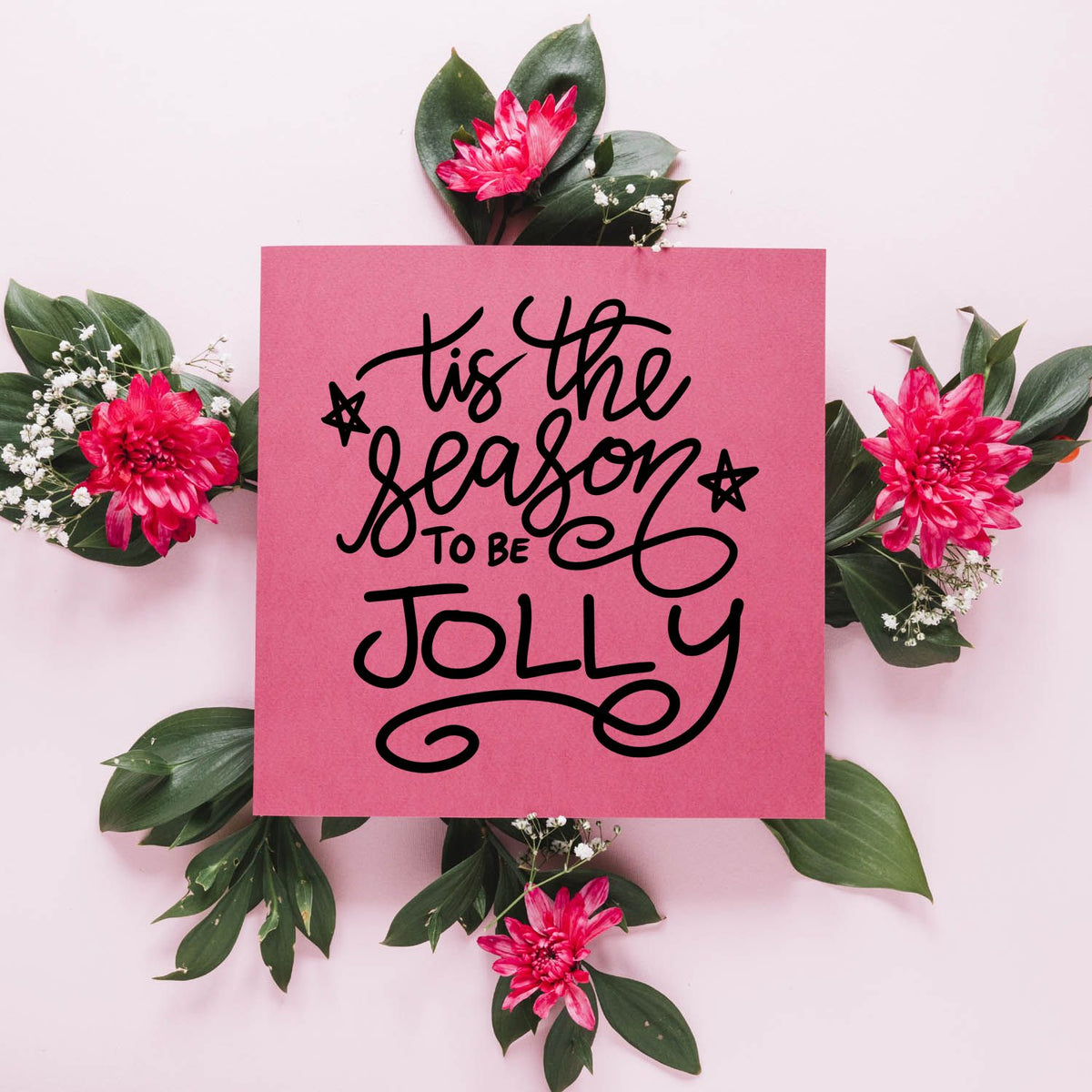 Christmas rubber stamp design with tis the season to be jolly hand-lettered text on a pink floral holiday card.