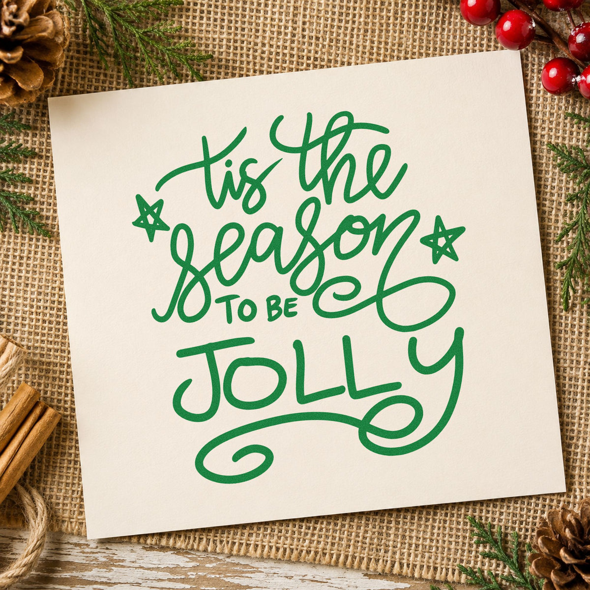 Tis The Season To Be Jolly craft stamp imprint in green ink on a handmade project, one idea being framed craft table.