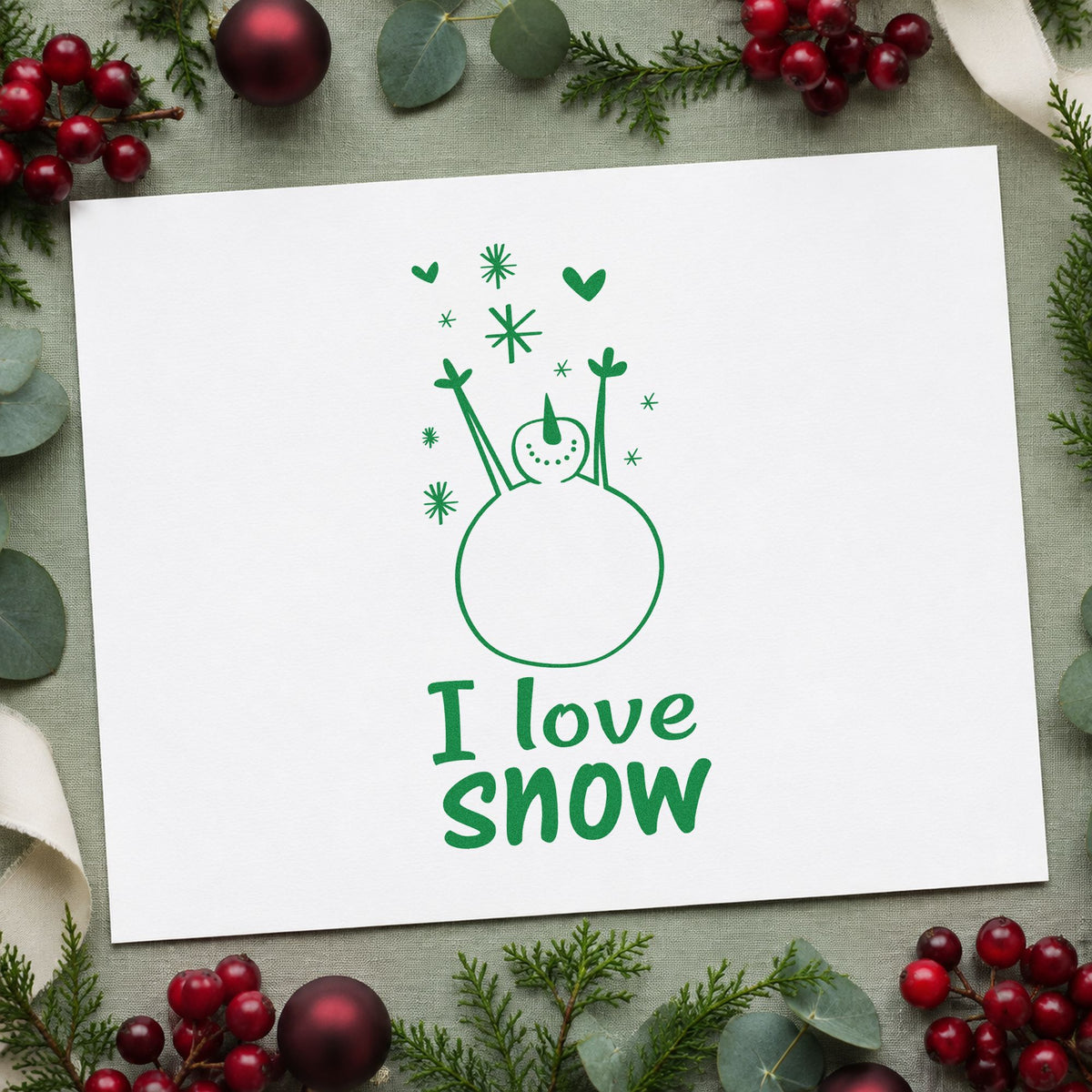 I Love Snow Snowman craft stamp imprint in green ink on a handmade project, one idea being framed nursery snow.