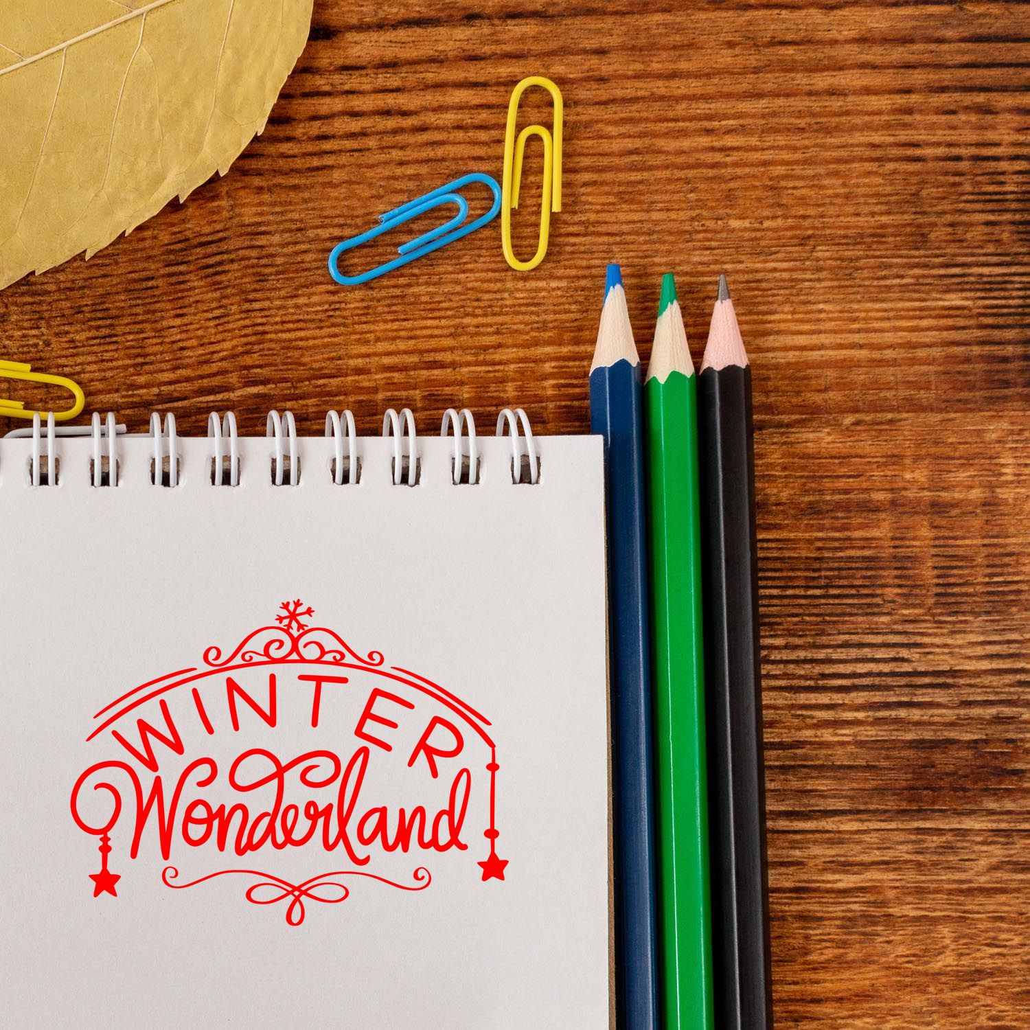 Winter Wonderland decorative rubber stamp imprint on a notebook page, ideal for holiday crafts, stationery, and branding.