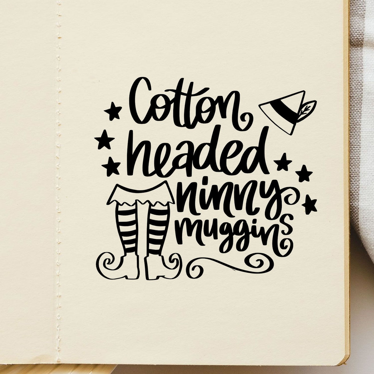 Christmas rubber stamp design reading Cotton headed ninny muggins with elf legs, ideal for holiday card making and crafts.