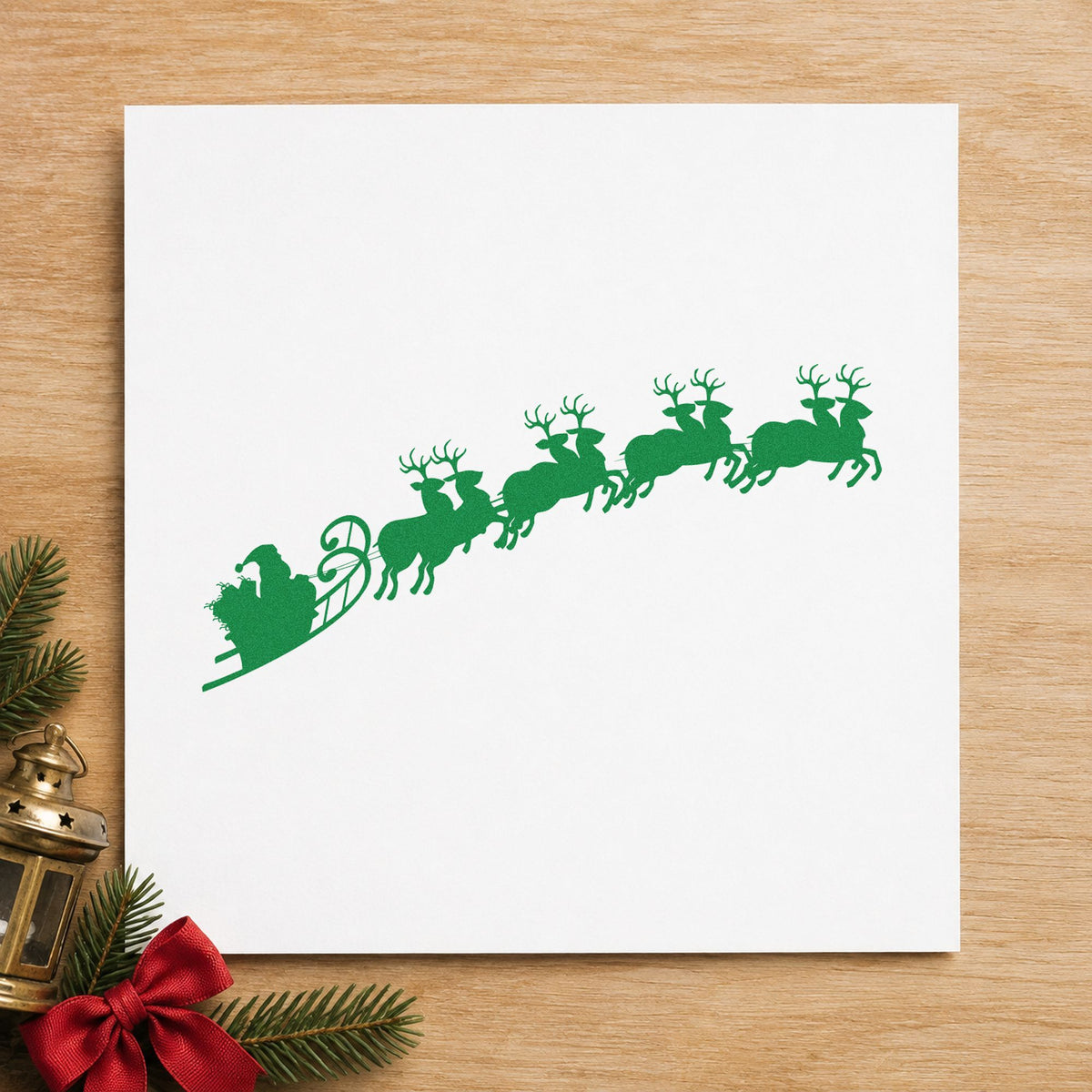 Santa Sleigh And Reindeer craft stamp imprinted in green ink on paper, a design suited to delivery bag seals.