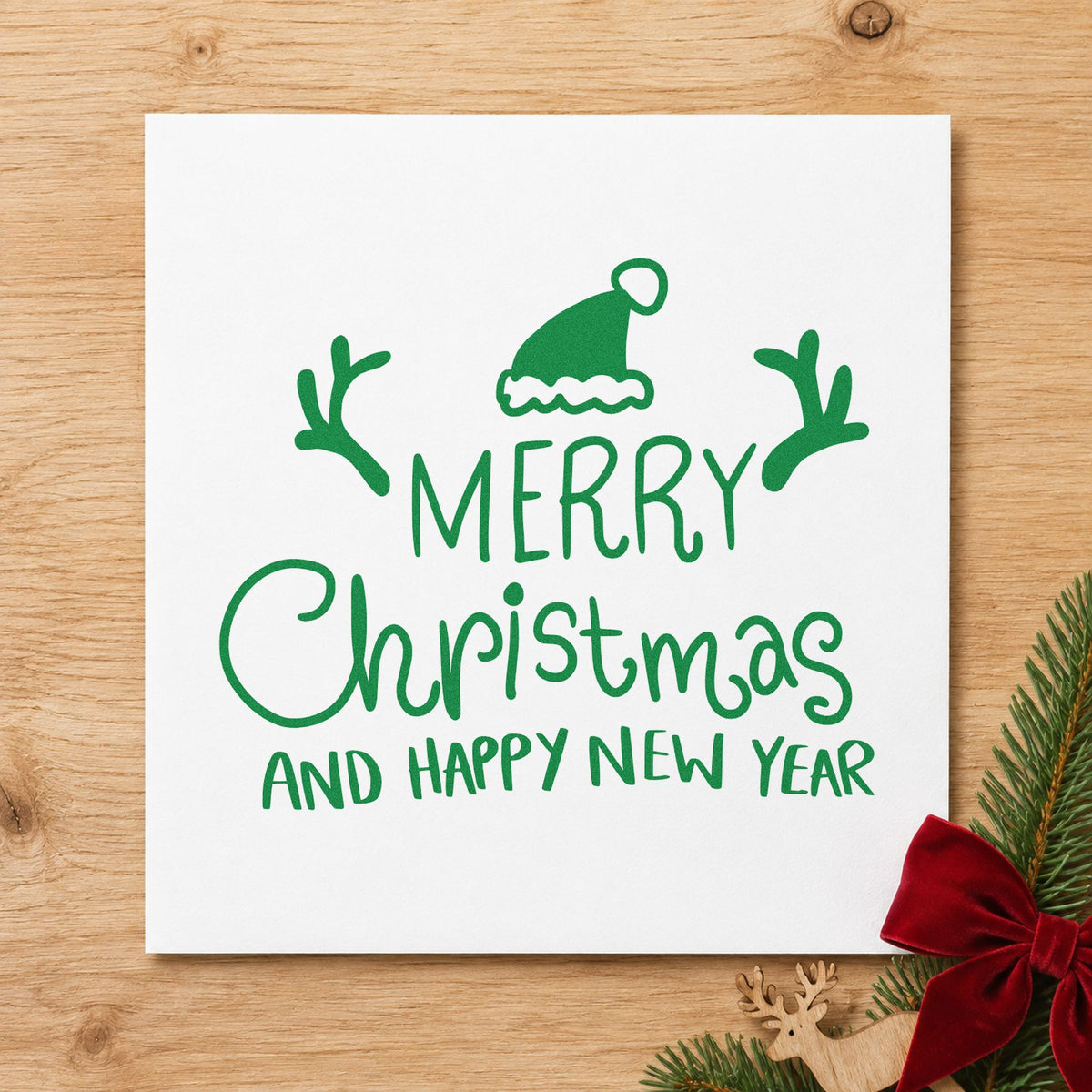 Merry Christmas Happy New Year craft stamp imprint in green ink on a handmade project, one idea being year plan pages.
