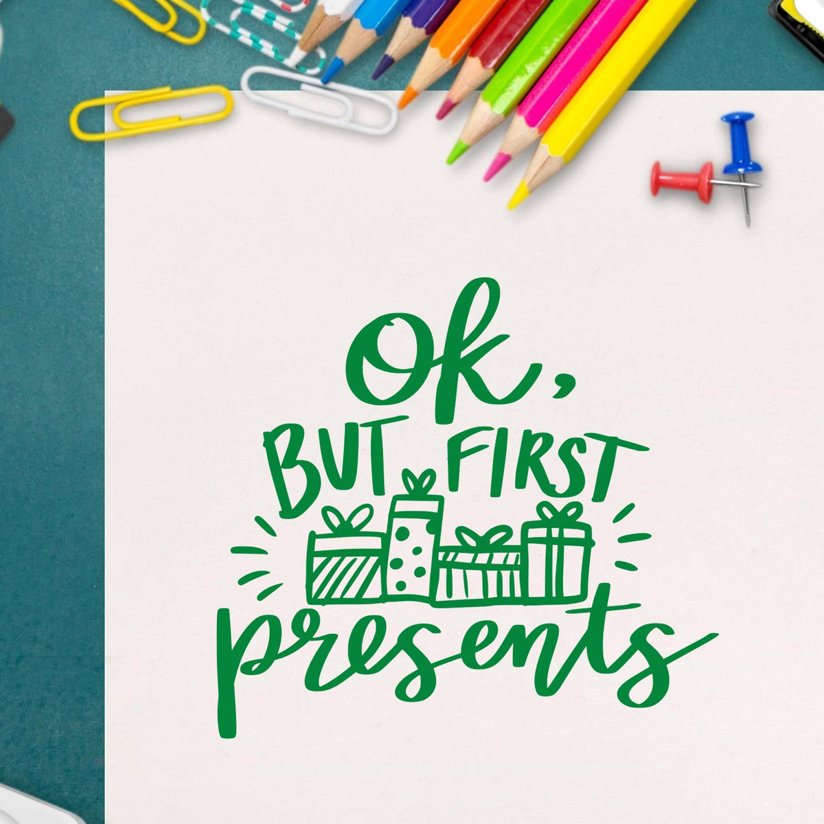 Ok But First Presents rubber stamp shown in green ink, stamped for projects such as opening order tags.