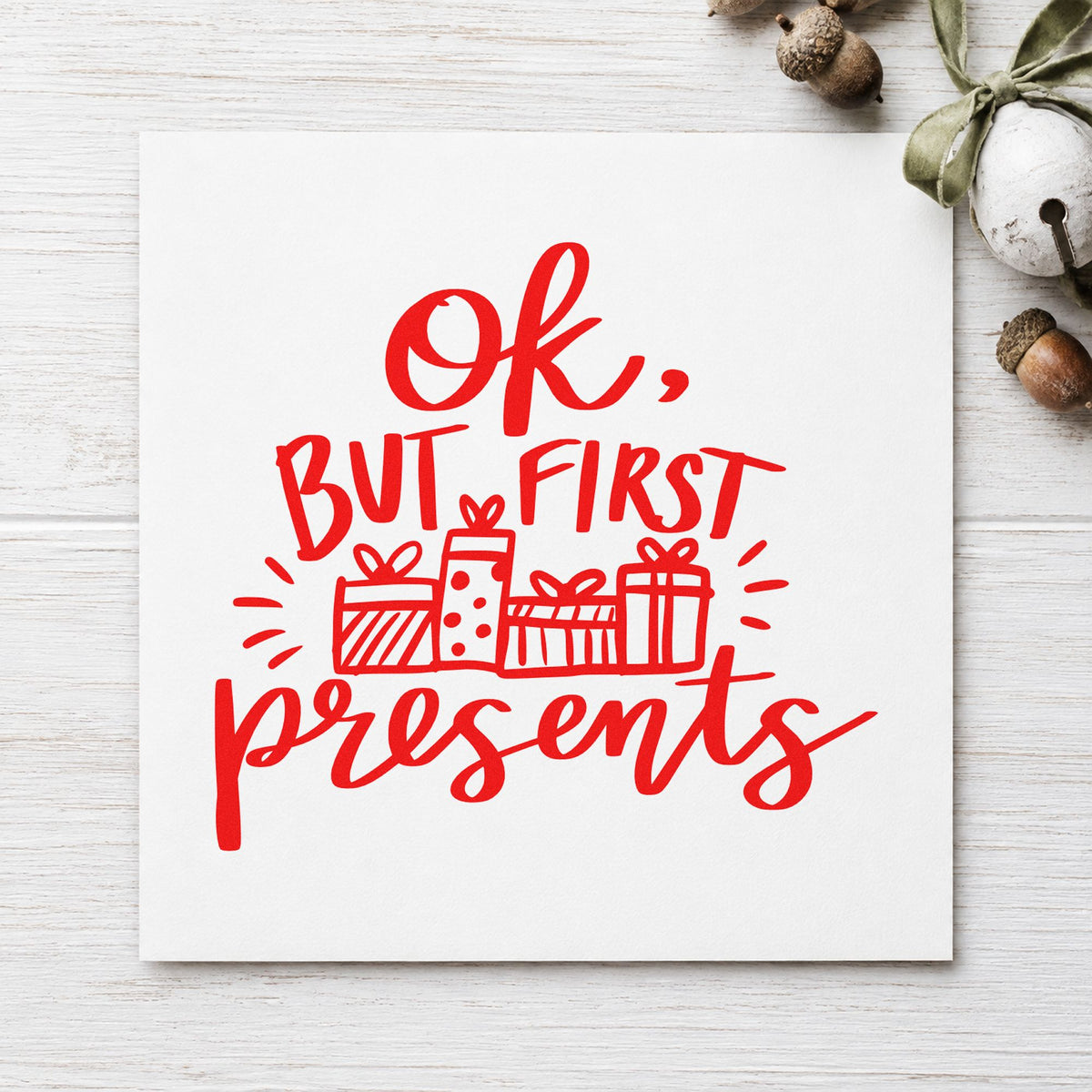 Ok But First Presents rubber stamp shown in red ink, stamped for projects such as christmas morning notes.