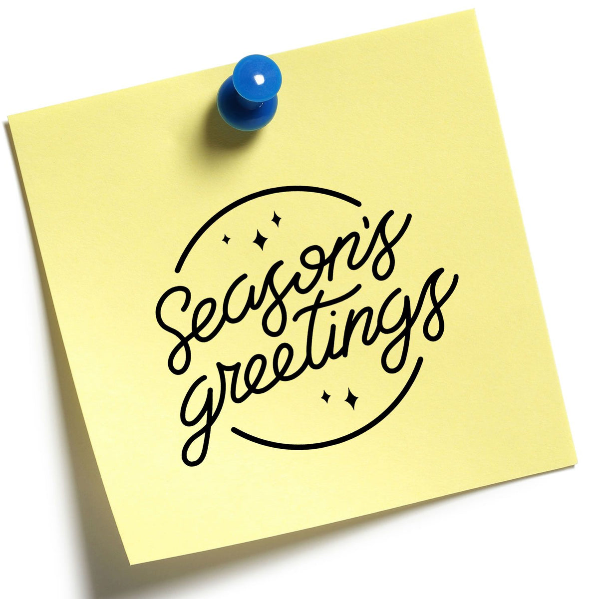 Seasons Greetings rubber stamp design on yellow sticky note with blue pushpin, perfect for holiday cards and packaging.