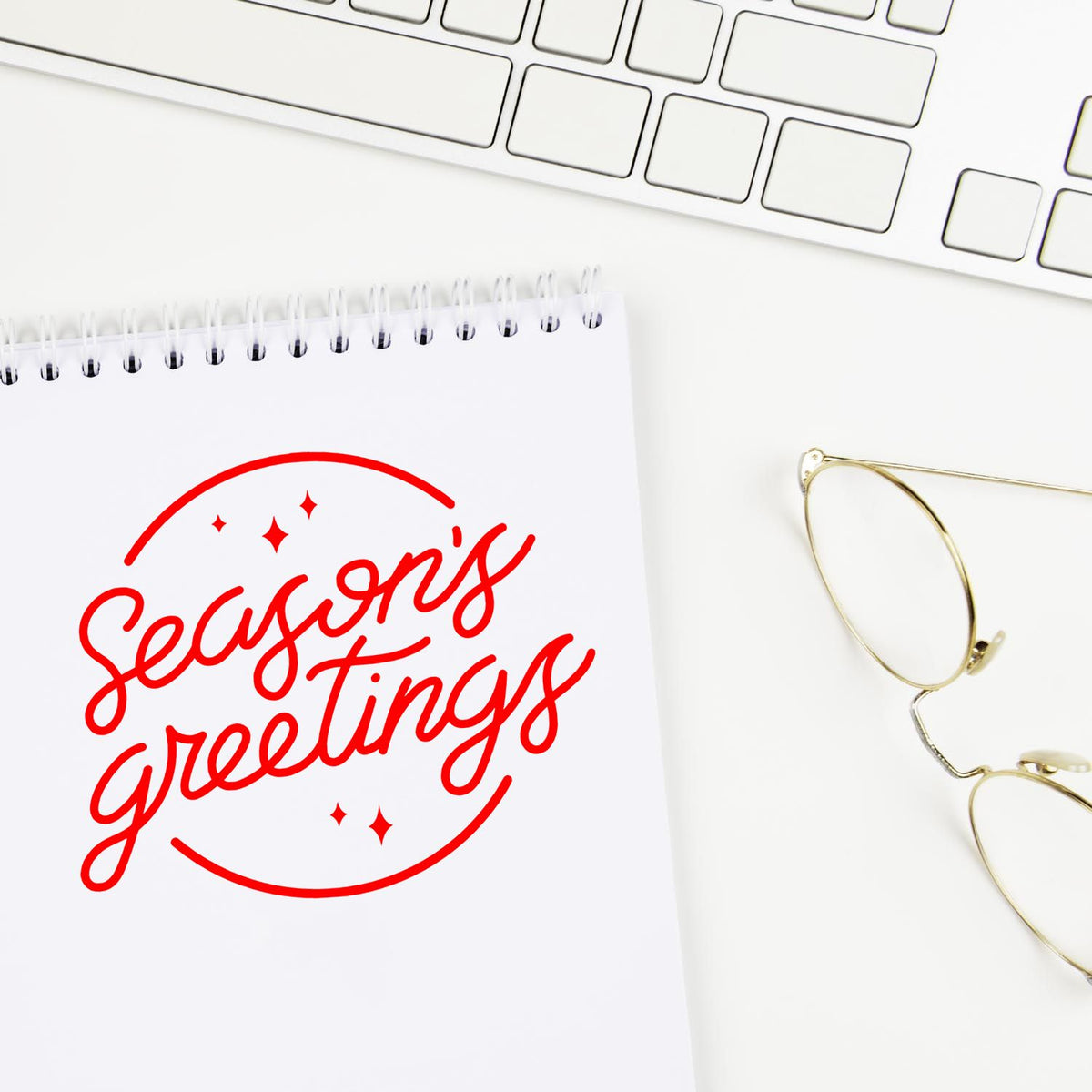 Seasons greetings rubber stamp design on notebook, showcasing a festive holiday stamp for cards and packaging.