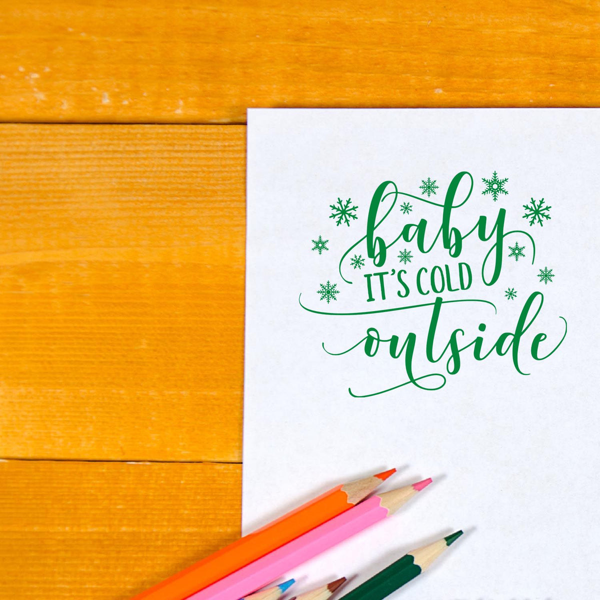Festive rubber stamp design reading Baby Its Cold Outside with snowflakes for holiday cards and scrapbooking.