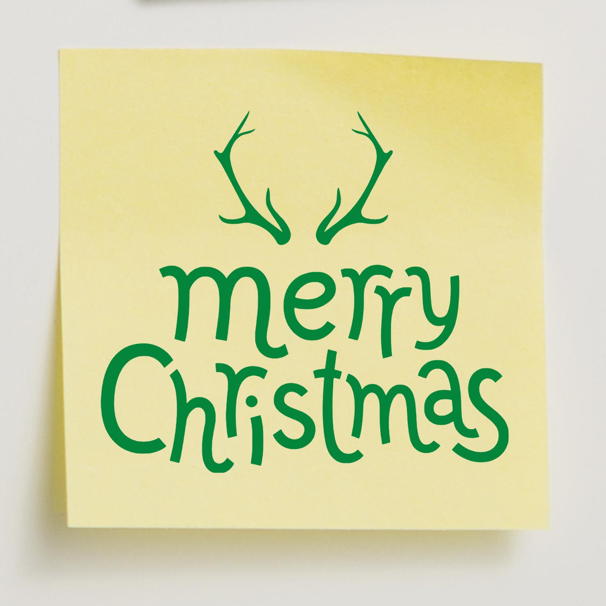 Merry Christmas rubber stamp design with antlers on yellow note, festive holiday greeting for card making and crafts