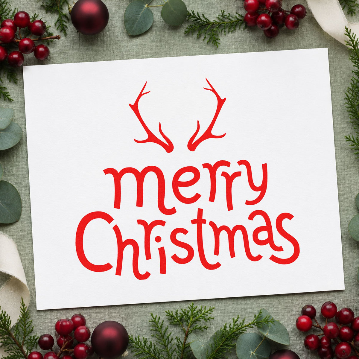Merry Christmas Antlers rubber stamp shown in red ink, stamped for projects such as pantry jar seals.