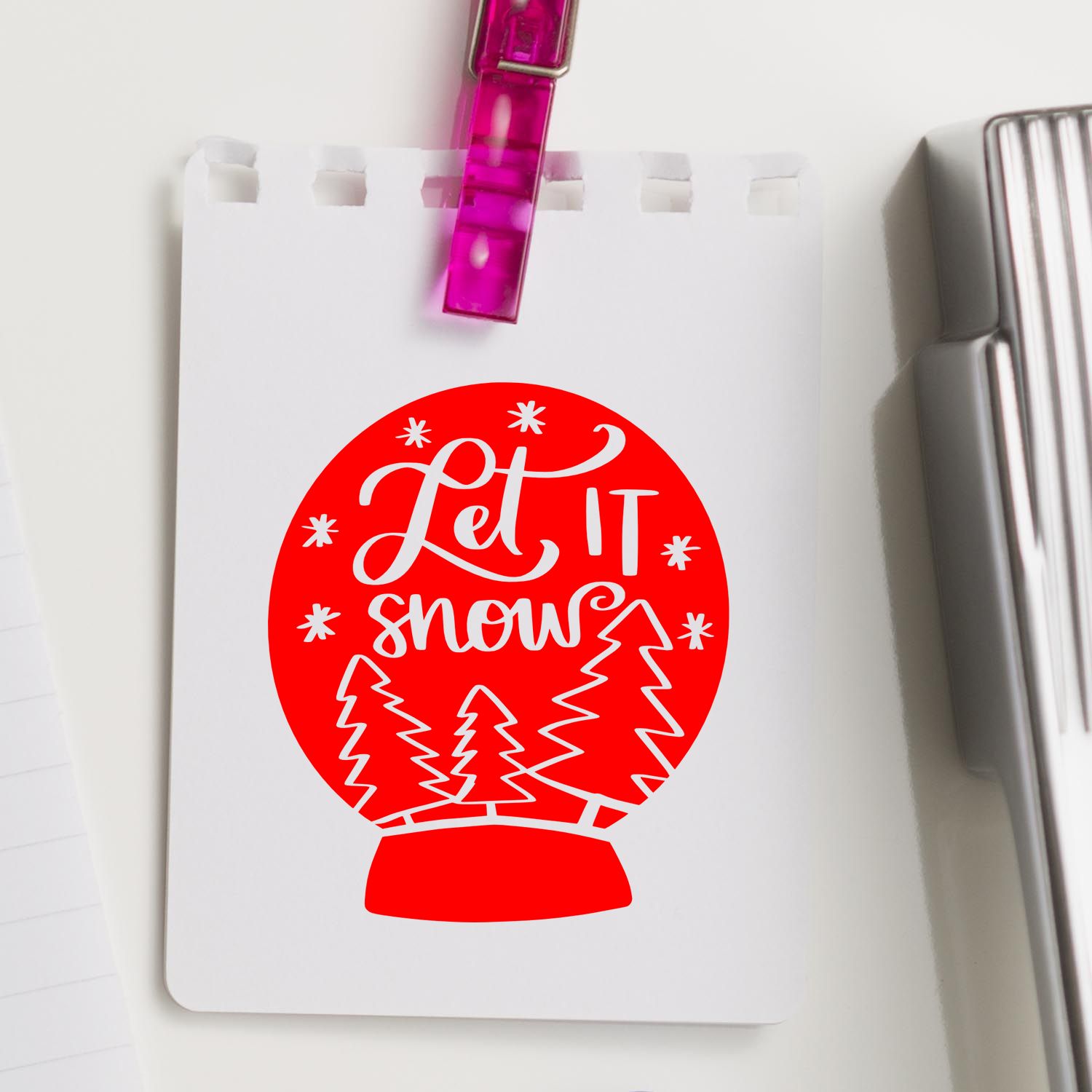Holiday rubber stamp design featuring a Let It Snow snow globe with pine trees, ideal for Christmas crafts and seasonal stamping.