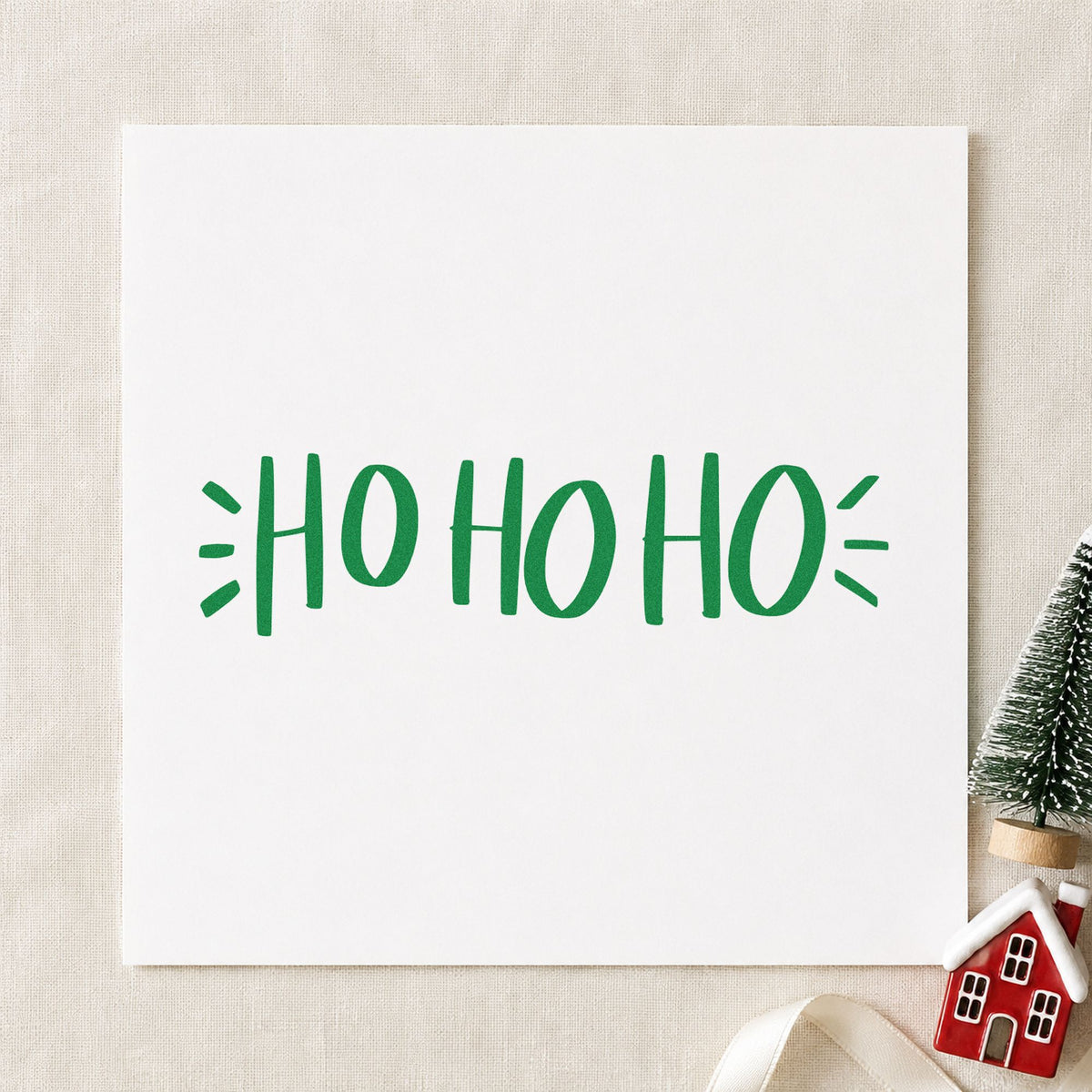 Ho Ho Ho Lettering craft stamp imprint in green ink on a handmade project, one idea being breakfast event passes.