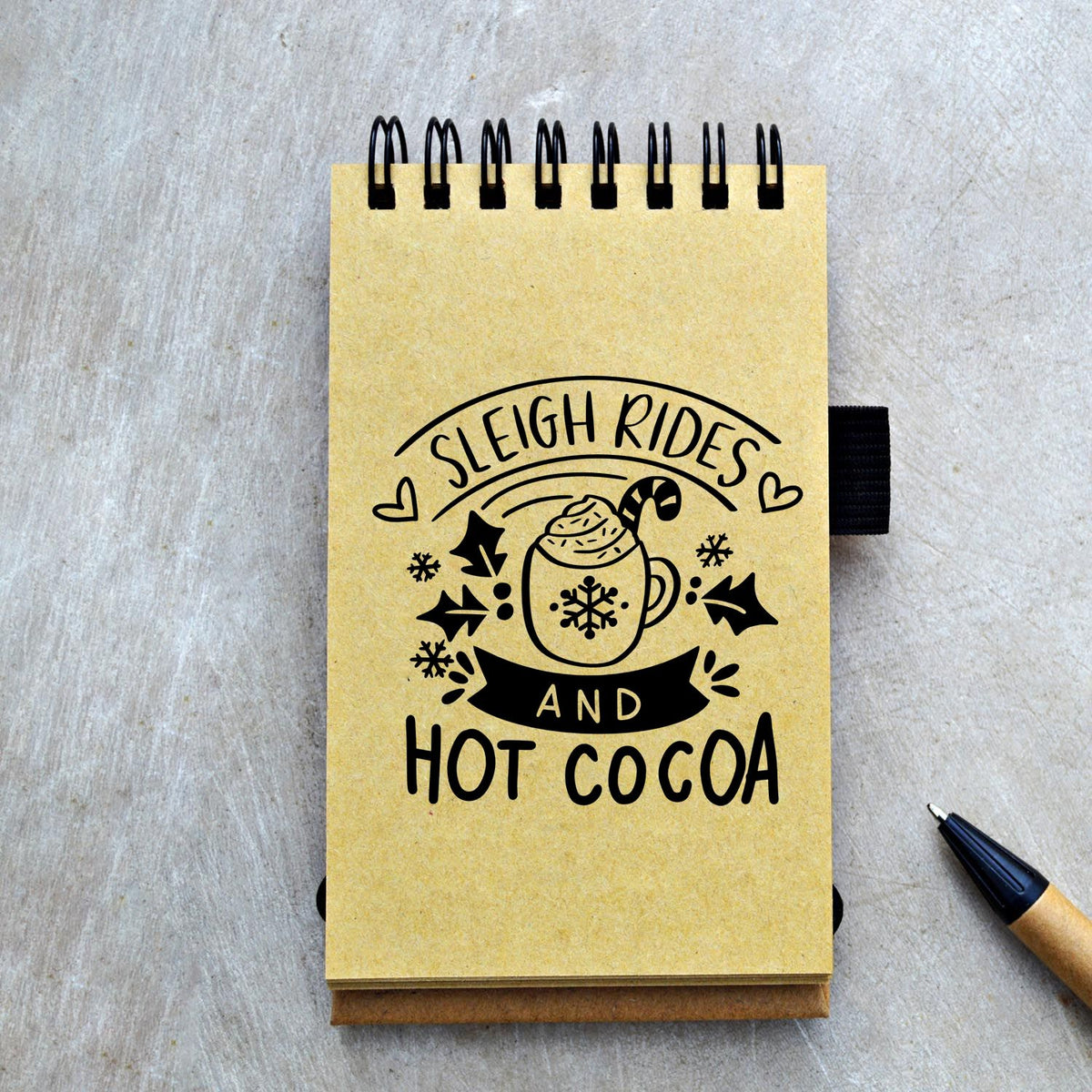 Sleigh Rides And Hot Cocoa Snowflakes PSI Pre-Inked Stamp imprint stamped in blue ink. “Sleigh Rides and Hot Cocoa” surrounds a whipped-cream mug with snowflake, hearts, stars, and dark banner.