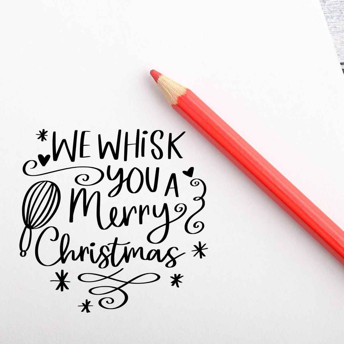 Whimsical Christmas baking rubber stamp reading We Whisk You a Merry Christmas with whisk and festive swirls.