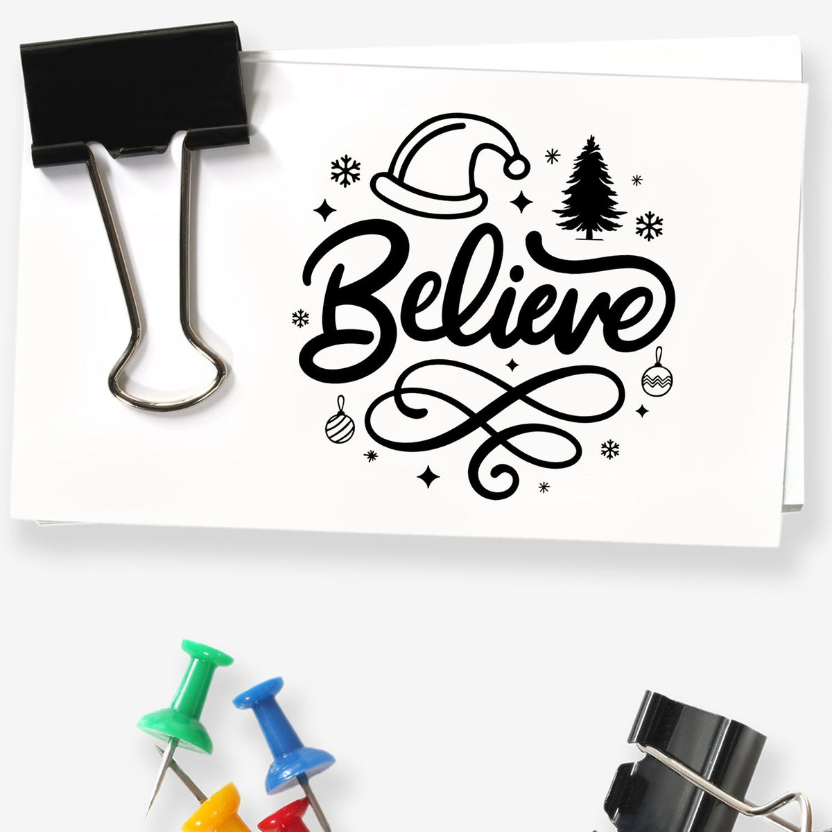 Christmas rubber stamp design with Believe, Santa hat, pine tree, ornaments and snowflakes for holiday card making.