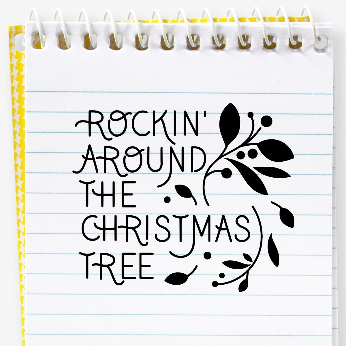 Christmas rubber stamp with Rockin Around the Christmas Tree lettering and festive foliage for holiday card making.