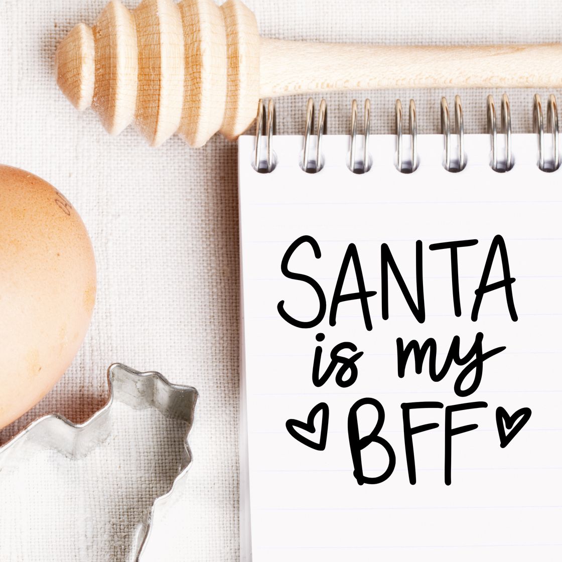 Holiday rubber stamp design reading Santa is my BFF for Christmas cards, with rustic baking props and cookie cutter.